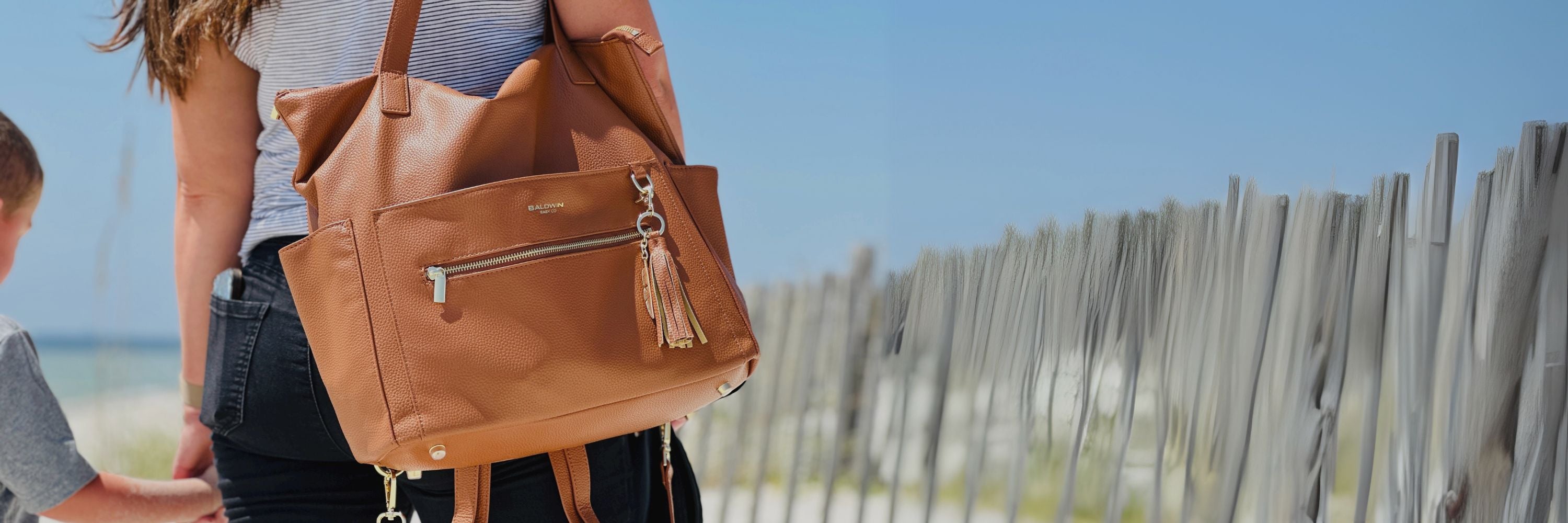 Wide banner of Baldwin Baby Co diaper bags in various colors and styles, showcasing fashionable and functional baby bags for modern parents.