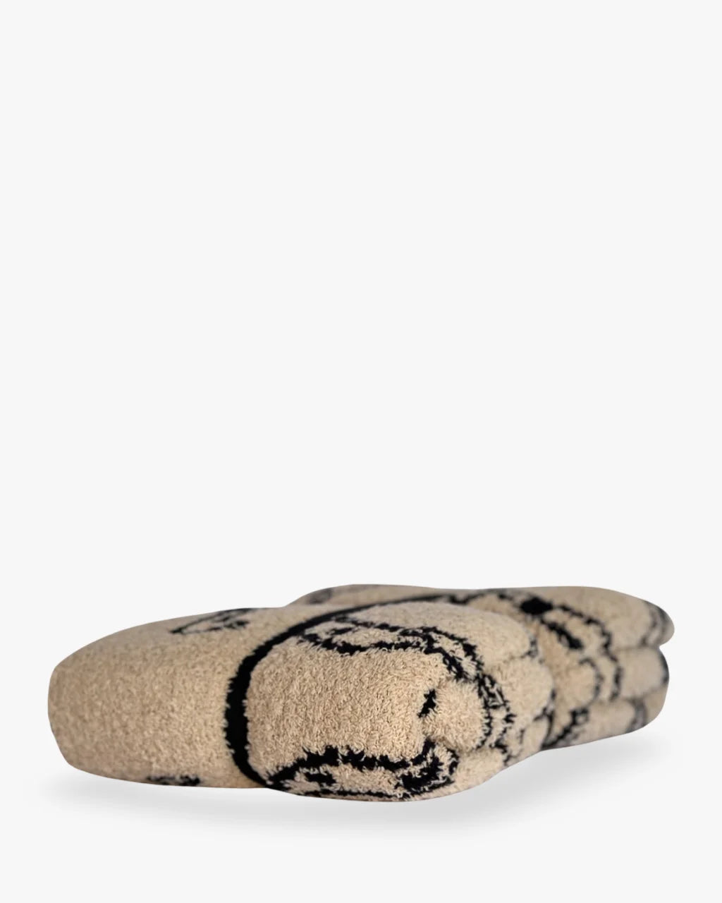 Close-up of folded baby blanket with detailed horseshoe print and plush texture