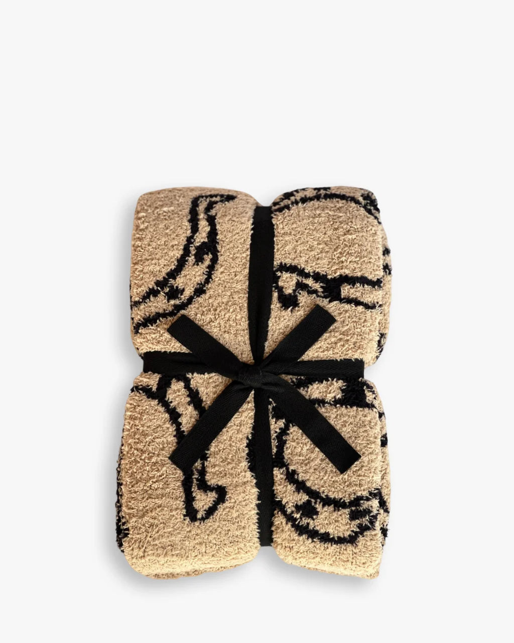Neutral baby blanket with black horseshoe print, tied with black bow for gifting