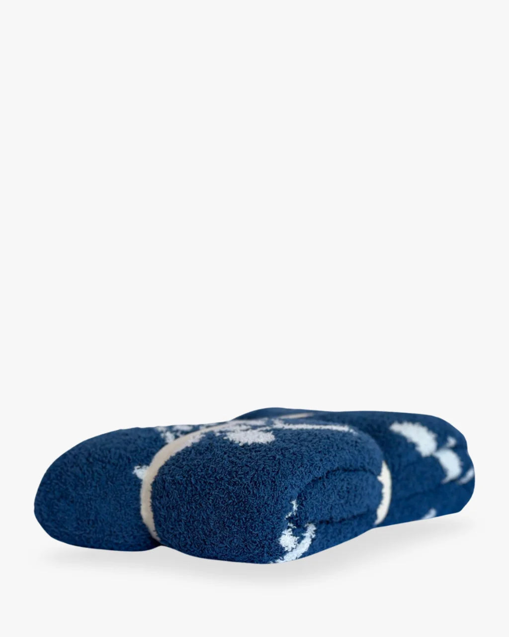 Side view of folded Sea Turtle Blanket in blue and white, showing soft plush texture