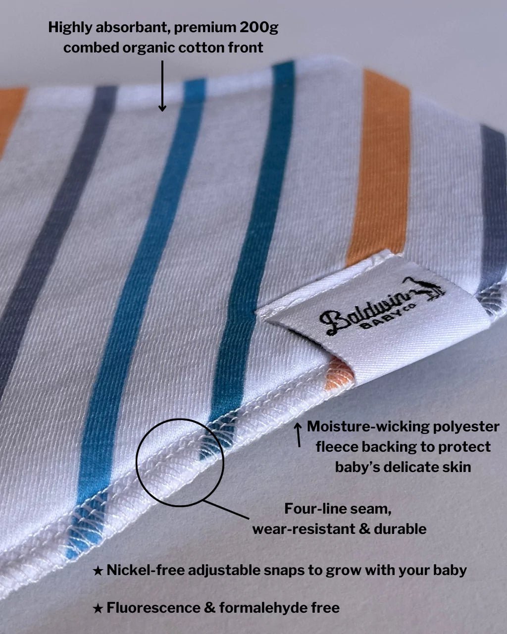 Close up of white, blue, gray, and orange striped pattern bandana bib with a white Baldwin Baby Company logo tag