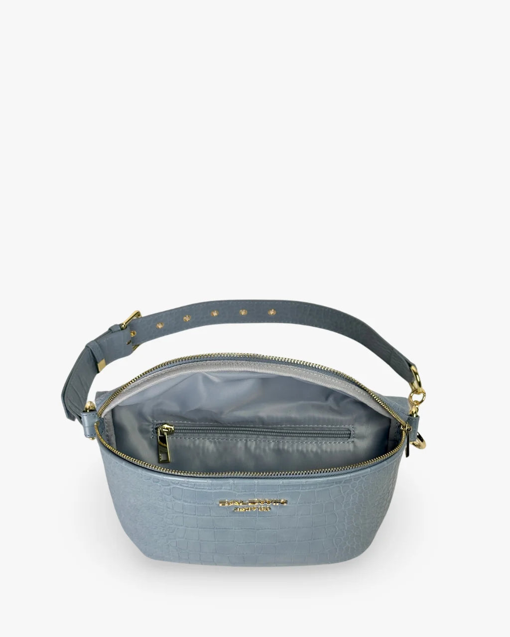 Interior of blue faux croc belt bag with red satin lining and zippered pocket
