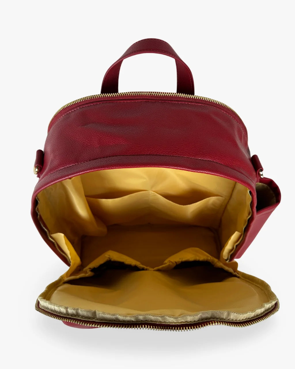 Open red diaper backpack with tan lining and multiple pockets for organized storage