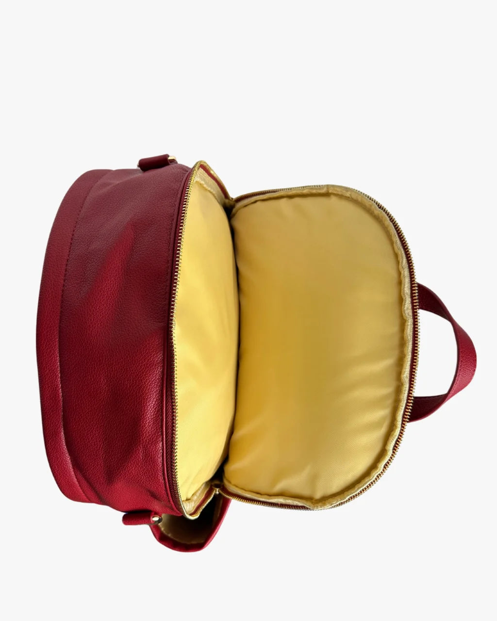 Top view of red diaper backpack with padded laptop sleeve and tan lining