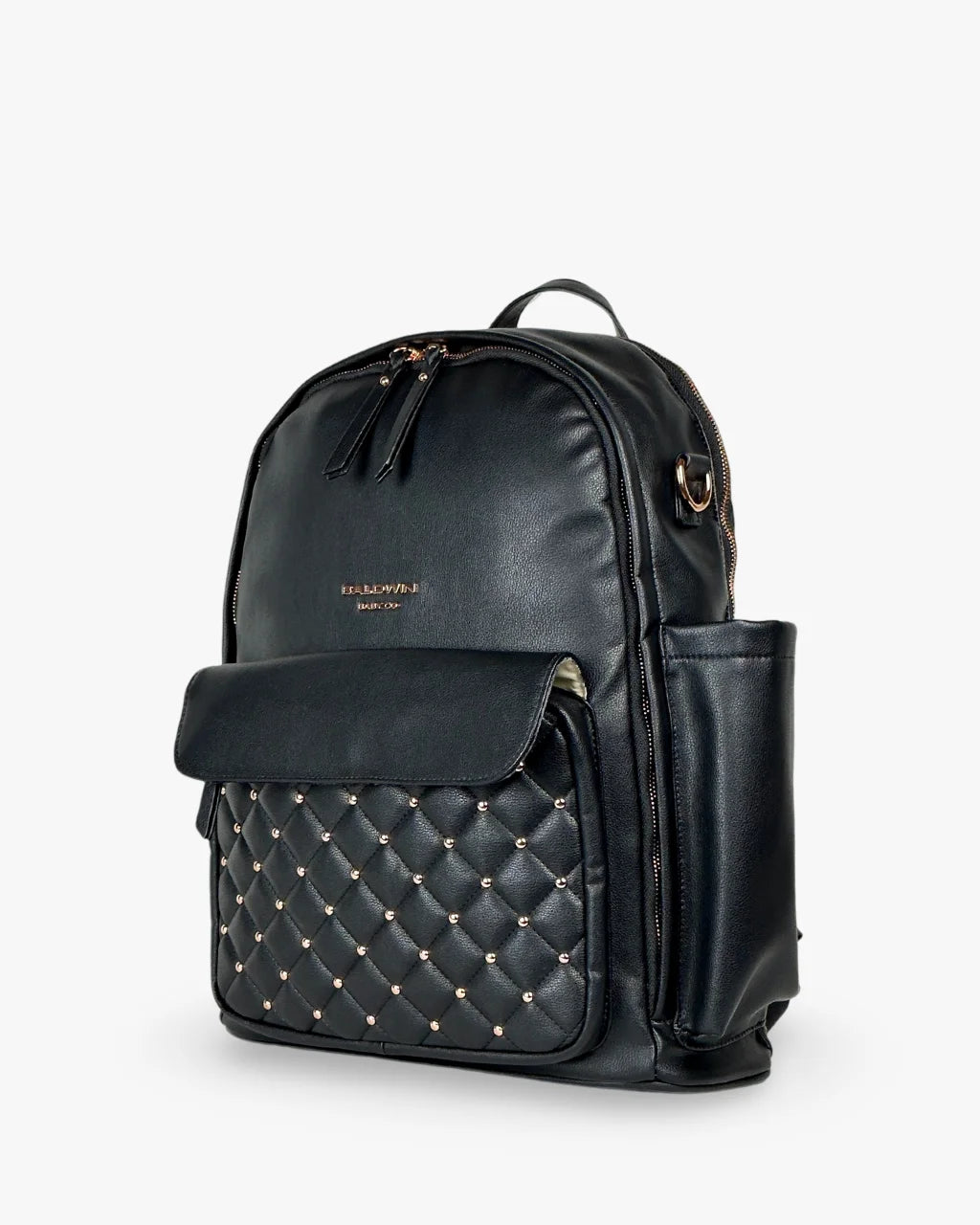 Angled side view of the black diaper bag backpack highlighting its side bottle holder, quilted front pocket, and structured silhouette.