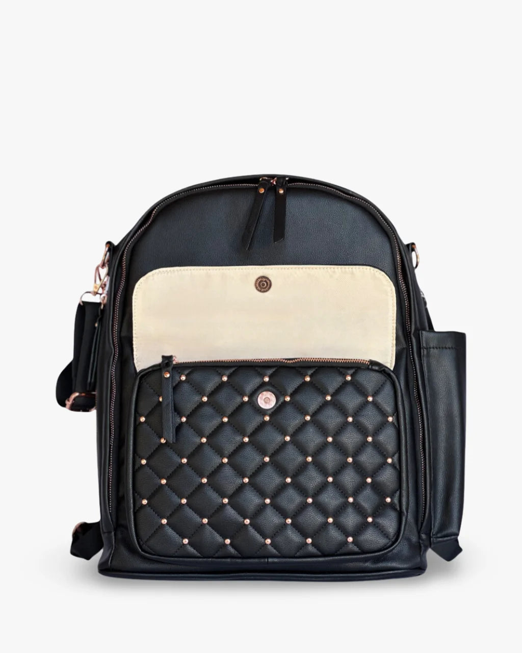 Close-up of the front flap on the black diaper bag, showcasing its cream interior and a quilted design with gold stud accents and a concealed zippered pocket.