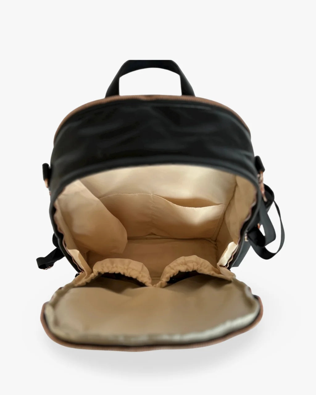 Open view of the black vegan leather diaper bag backpack showing its cream lined spacious interior with multiple pockets for organization.