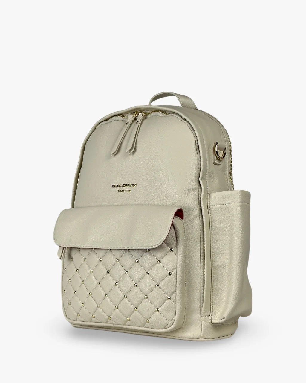 Angled side view of the gray-beige diaper bag backpack highlighting its side bottle holder, quilted front pocket, and structured silhouette.
