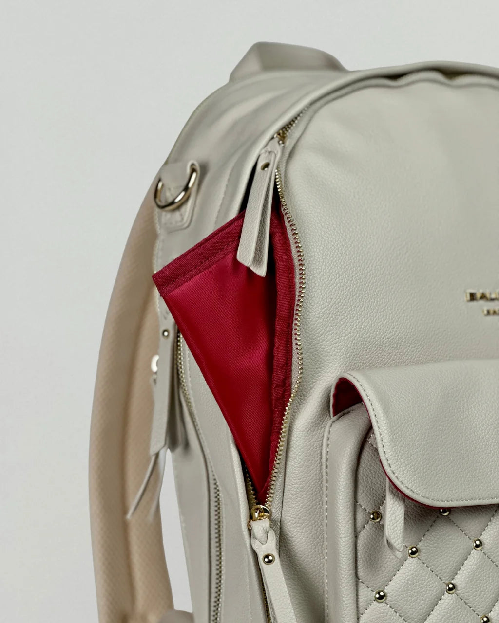 Close-up of the red changing pad included with the gray-beige diaper bag, offering convenient functionality for parents on the go.