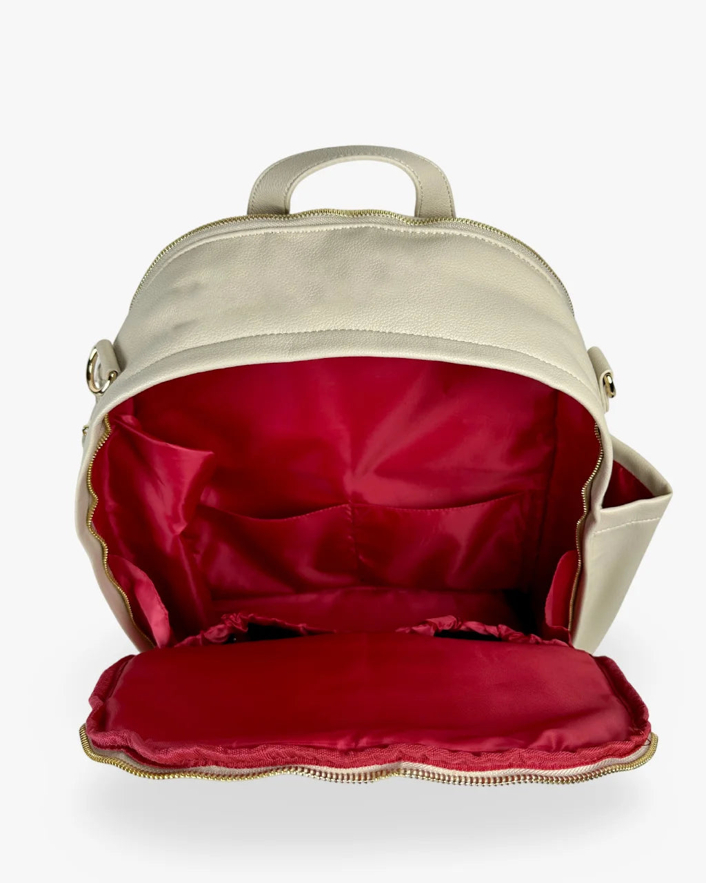 Open view of the gray-beige vegan leather diaper bag backpack showing its red lined spacious interior with multiple pockets for organization.