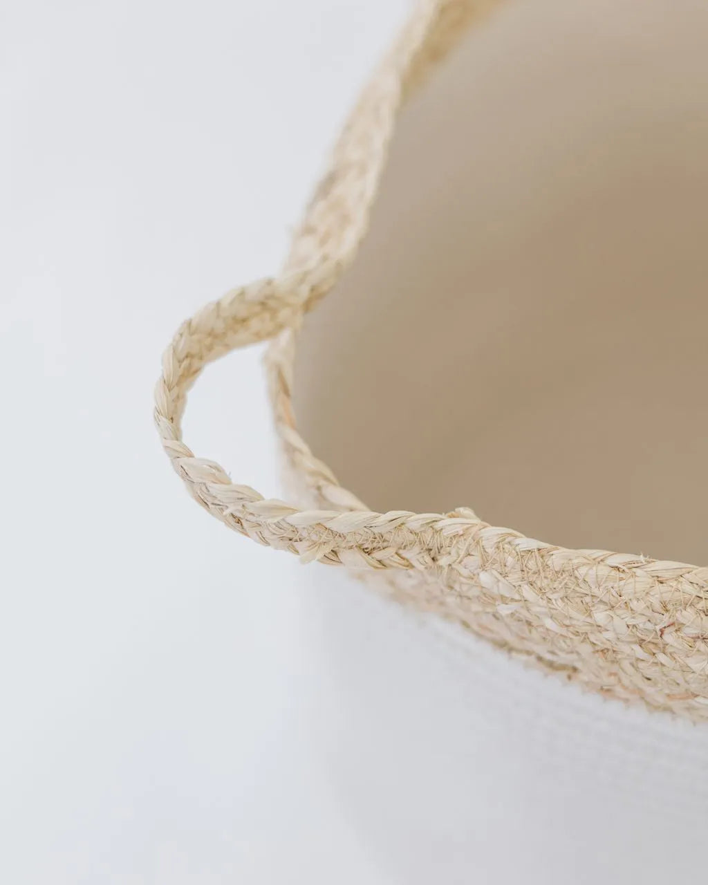 white bell shaped rope basket with corn husk details and handles