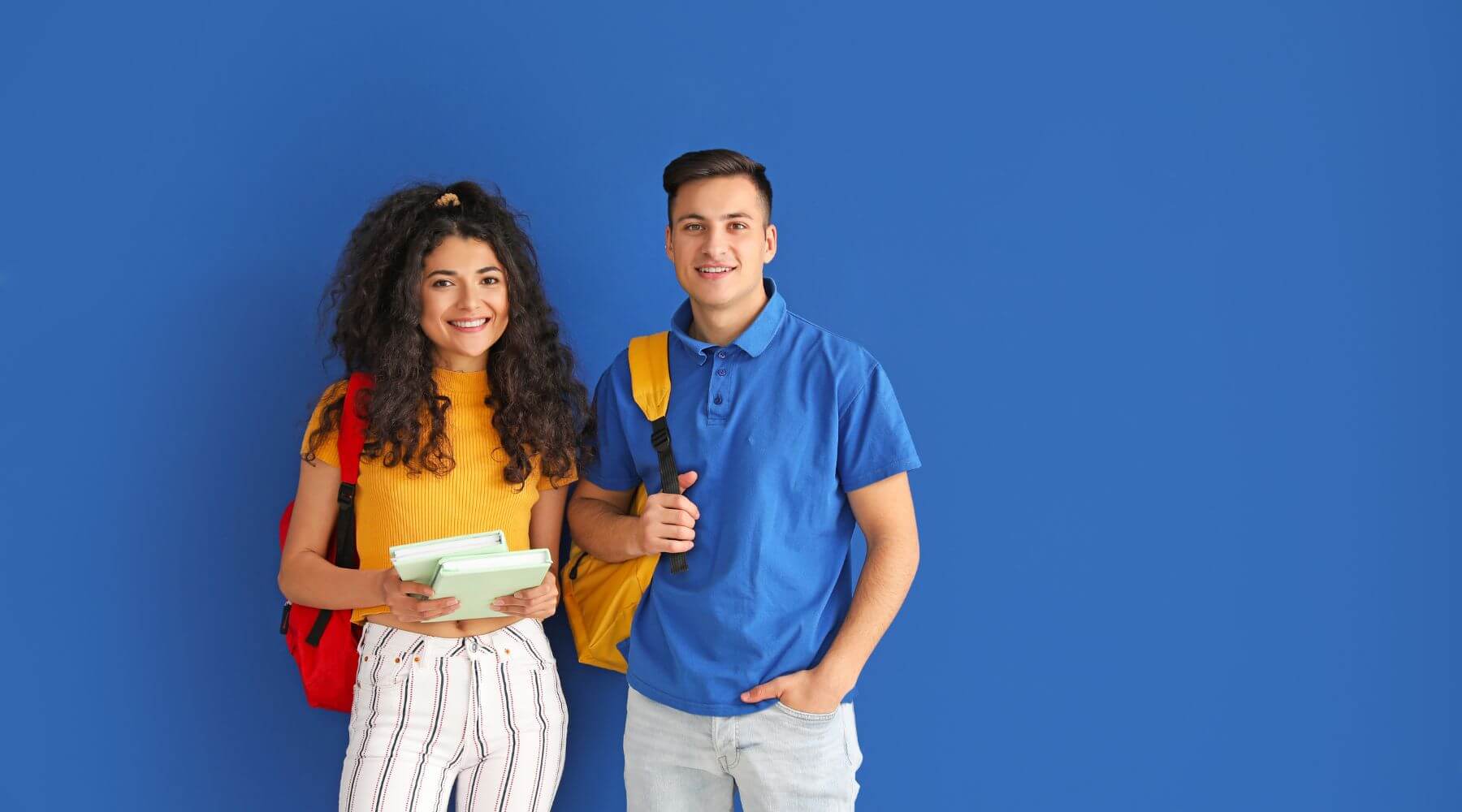 young adults wearing backpacks