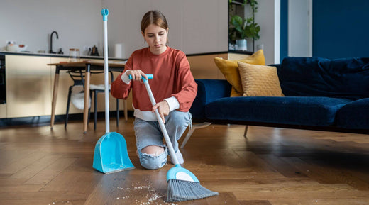 teen sweeping the floor