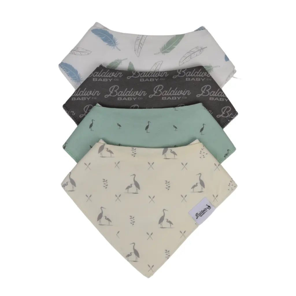 Set of four Baldwin Baby Co's signature style bandana bibs on a white background