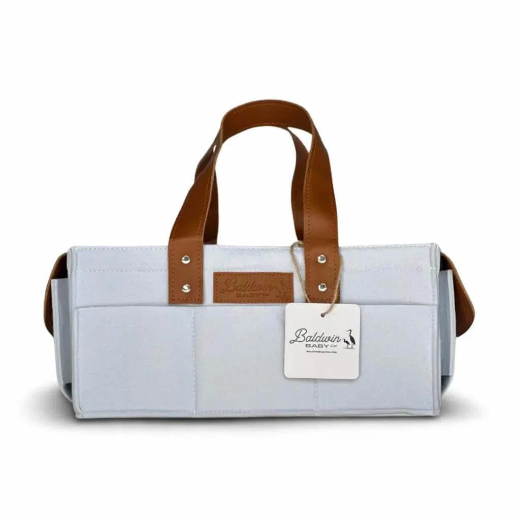 white with a hint of blue diaper caddy made of felt with leather accents and straps