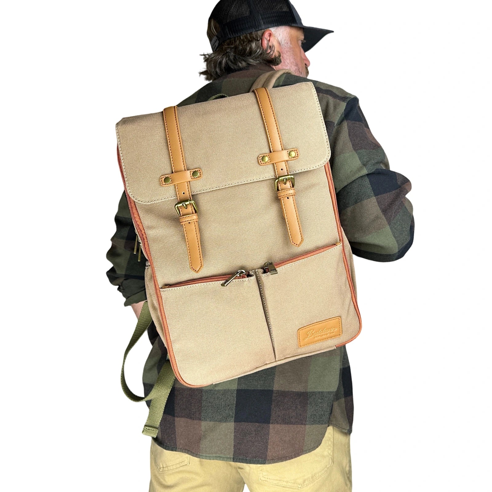 man modeling canvas diaper bag backpack over one shoulder