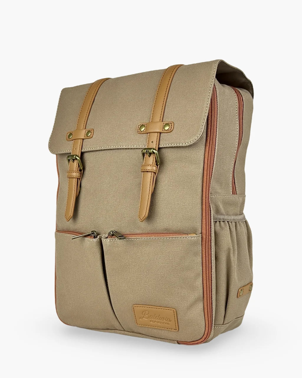 Angled view of the beige canvas diaper backpack highlighting its structured design, tan leather accents, and dual front pockets with zipper closures.