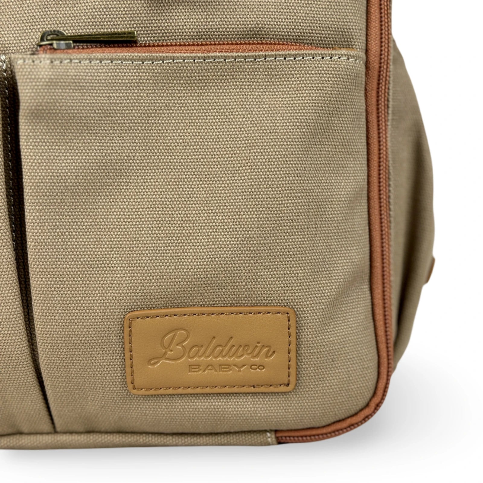 close up of Baldwin Baby Co logo on front of canvas diaper bag backpack