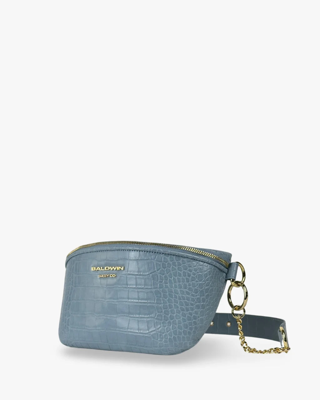 Angled view of a blue faux crocodile crossbody belt bag with a zippered top, gold hardware, and the Baldwin Baby Co. logo embossed in gold