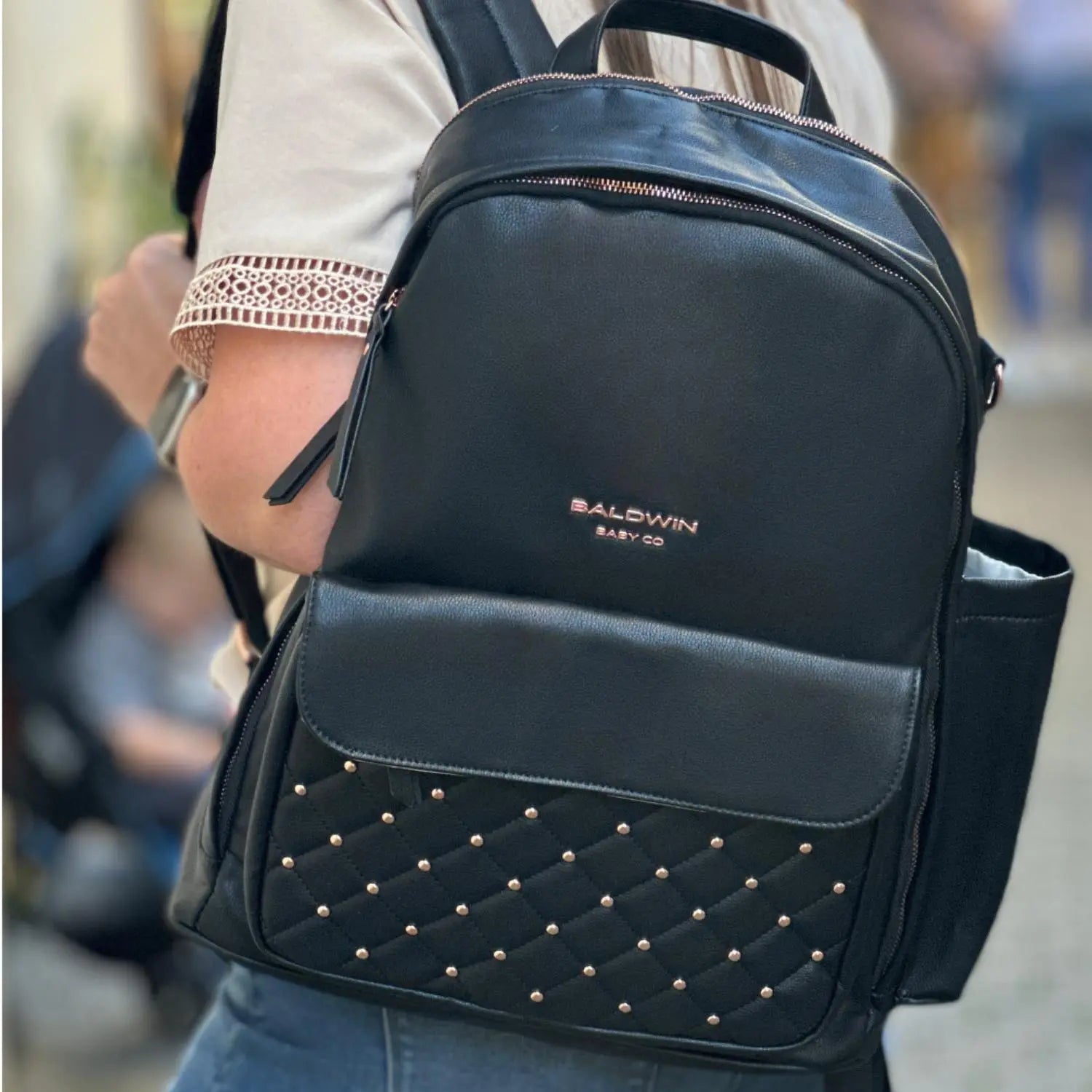 black vegan leather diaper bag backpack with rose gold studs and accents