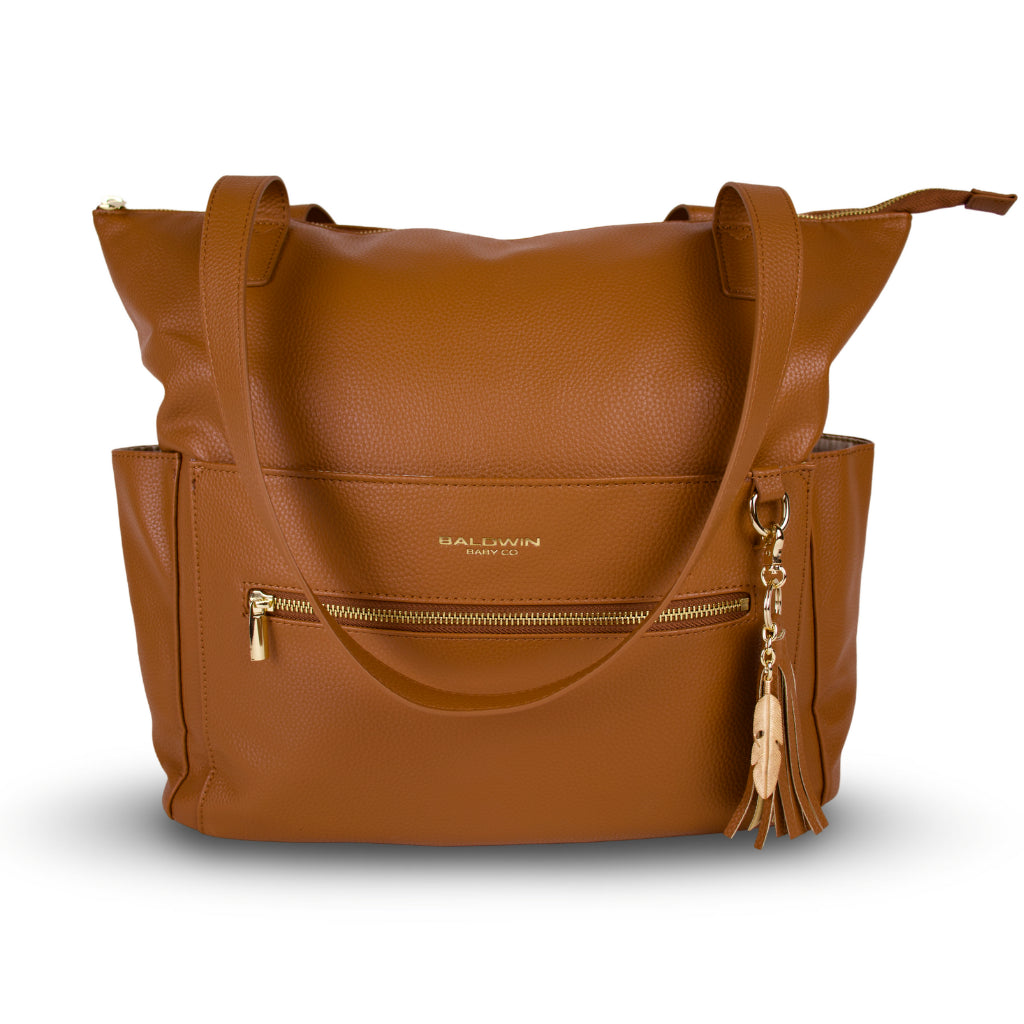 Brown leather diaper bag with leather and gold feather tassel