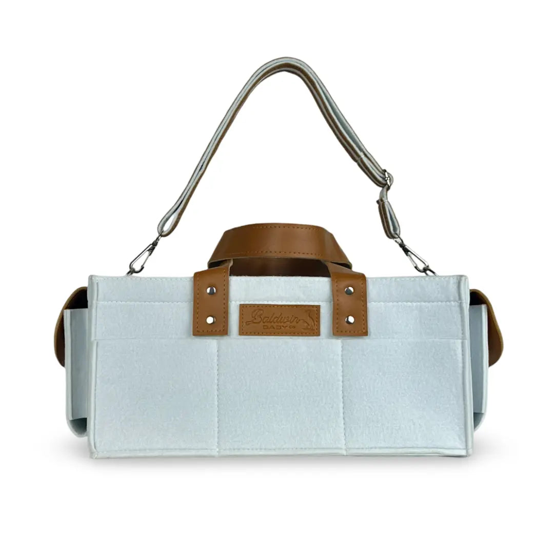 white with a hint of blue diaper caddy made of felt with leather accents and straps