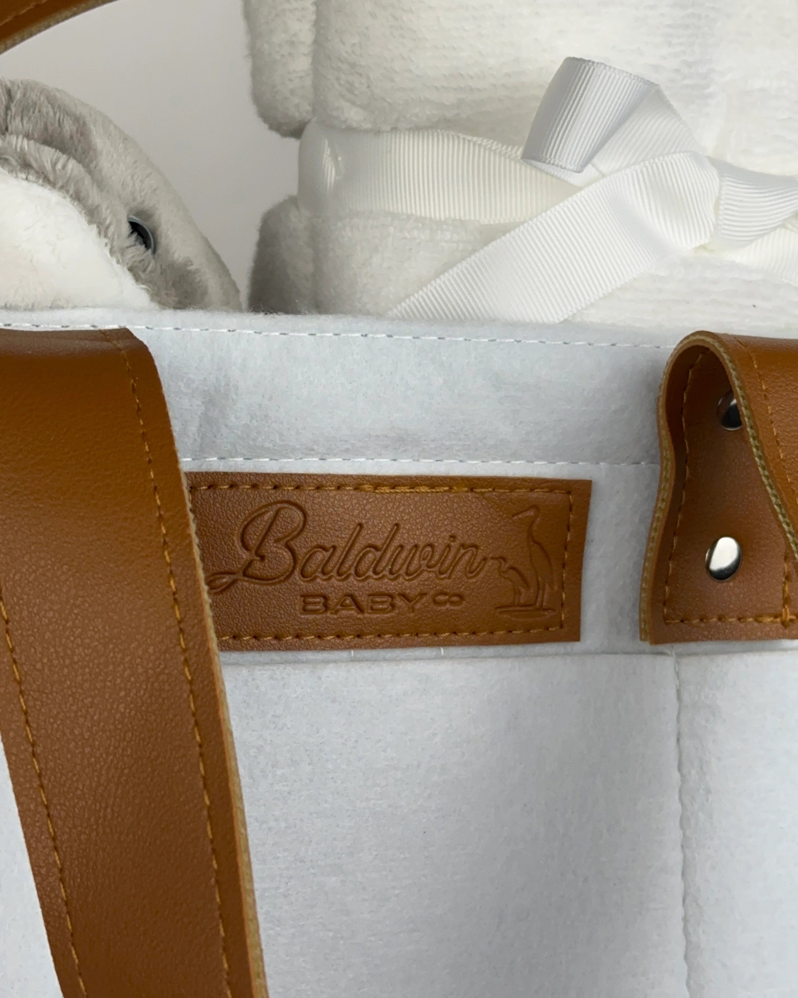 Baldwin Baby Co logo on felt diaper caddy