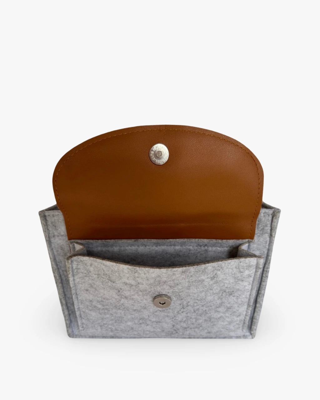 side view of a heather gray diaper caddy made of felt displaying open pocket with leather flap