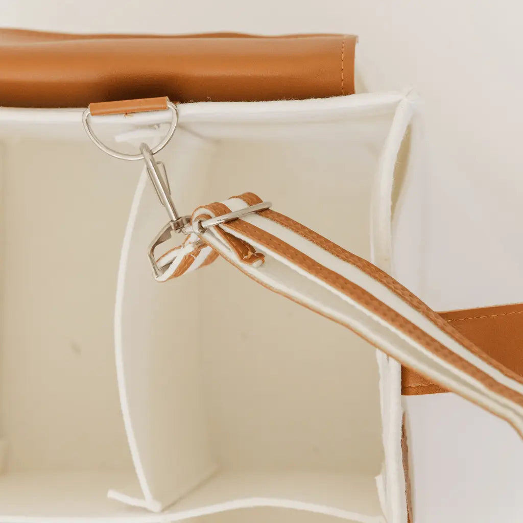 White felt diaper caddy with brown leather handles and accents