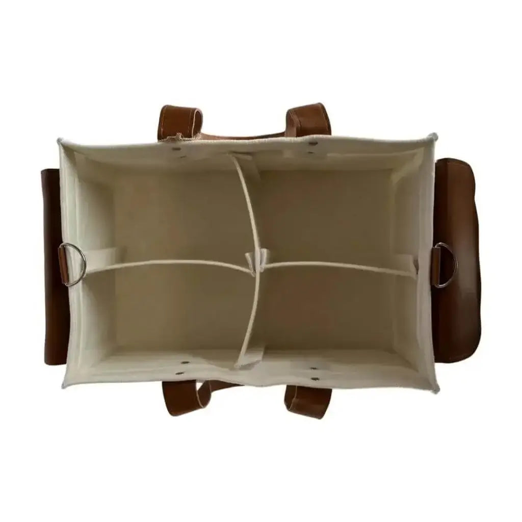overhead view of creamy white diaper caddy made of felt with leather accents